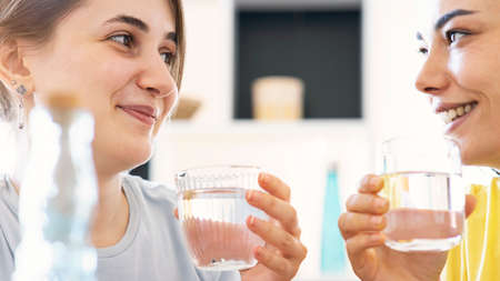 friends drinking a fresh glass of water at home