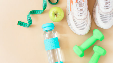 Fitness equipment on a brown background with copy space