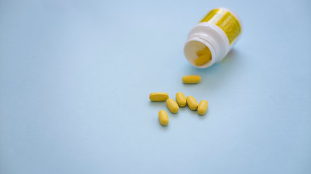 Assorted pharmaceutical medicine pills, tablets and capsules over blue backgroundの写真素材