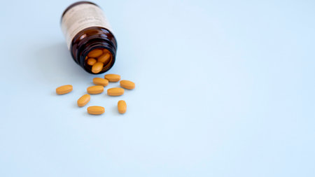 Assorted pharmaceutical medicine pills, tablets and capsules over blue backgroundの写真素材