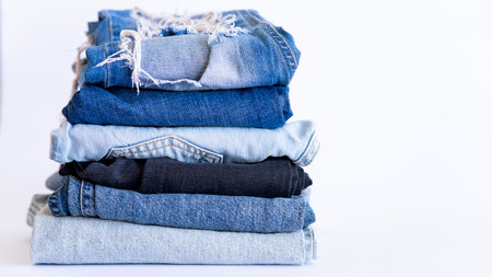 jeans on the background, blue and black jeans lie on a white background,