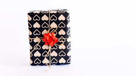 Gift box with red ribbon isolated on a white background.の写真素材