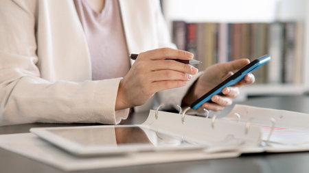 Close-up of the woman Holding Green Screen Smartphone in office Playing Game with His Thumbs.