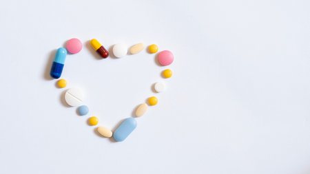 Pile of colorful medicine pills and capsules in blister packs.