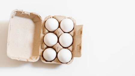 Organic white eggs in tray or egg box. Poultry Chicken eggs in carton for grocery or breakfast.