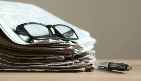 Pile of newspapers stacks on tableの写真素材