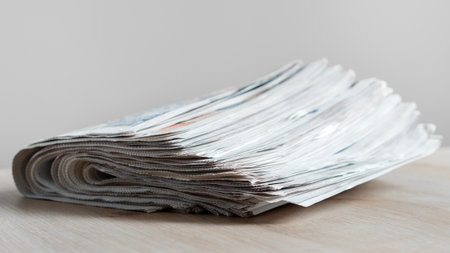 Pile of newspapers stacks on table