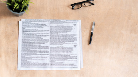 blurred newspaper on wood tableの写真素材