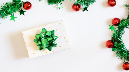 Christmas Eve concept. Top view photo of gift boxes with ribbon bows green red baubles gold star...