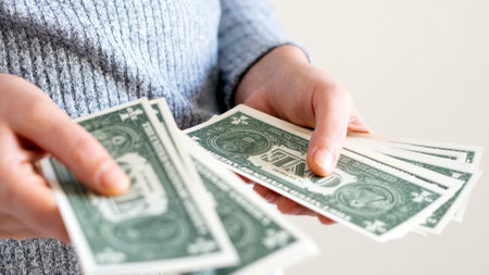 A woman hand offering dollar, euro notes and holding bunch of euro money. Euro, dollar banknotes, European Union paper currency. Saving money concept.の写真素材