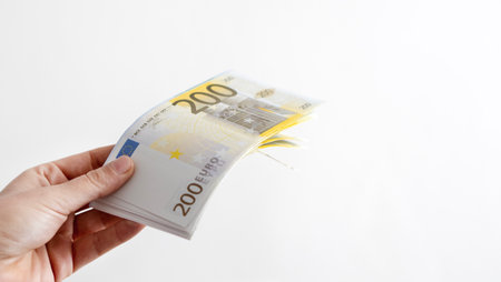 A woman hand offering dollar, euro notes and holding bunch of euro money. Euro, dollar banknotes,...
