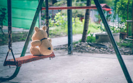 The brown dog doll playing is in the playground alone no kids.の写真素材