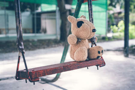 The brown dog doll playing is in the playground alone no kids.の写真素材