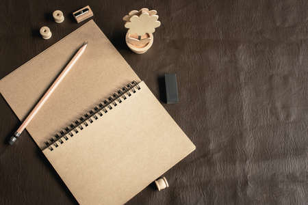 Tools writing  on the table are brown notebook ,wood pencil,pencil sharpener and eraser.Mockup conceptの写真素材