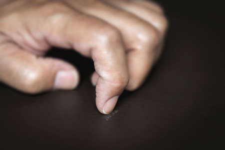 Asian man scraped the table with his fingernail because of stress. Symptoms depressionの写真素材