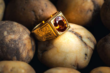 Close-up gold ring jewelry on river gravel background.Vintage ring,ancient jewelry,used for vintage backgroundの写真素材