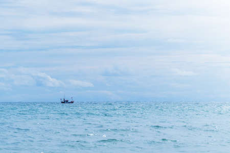 A small fishing boat sailing in the sea.In calm water in the  afternoon,bright sunlight,sea in thailandの写真素材