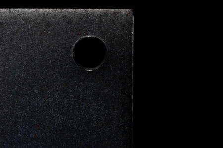 Close-up texture of  steel plate,has a hole ,for black tone backgroundの写真素材