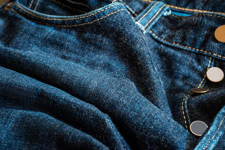 Denim texture of trousers jeans,  with seam and yarn and brass buttons for design ,vintage styleの写真素材