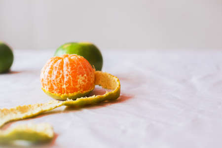 Close-up ,The oranges  on the  table on white backdrop .The oranges have green peel . The fruit have many vitamin C,peeling orangeの写真素材