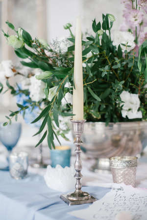 Silver candlestick as element of festive table wedding centerpieces decorations.の写真素材