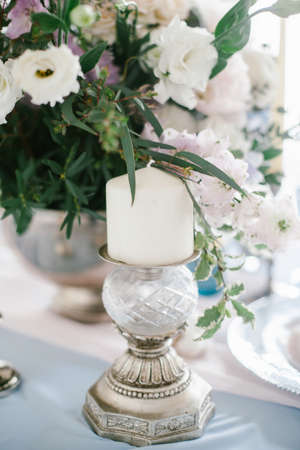 Silver candlestick as element of festive table wedding centerpieces decorations.の写真素材