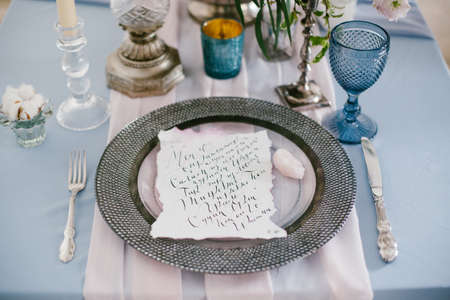 Graphic arts of beautiful wedding calligraphy cards and silver plate on festive wedding table. の写真素材