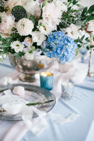 Graphic arts of beautiful wedding calligraphy cards and silver plate with cutlery on festive wedding table.の写真素材