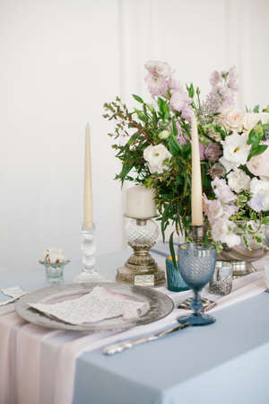 Silver candlestick and other elements of festive table wedding centerpieces decorations.の写真素材