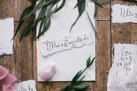 Graphic arts of beautiful wedding calligraphy cards with flower and mineral stone on wood background.の写真素材