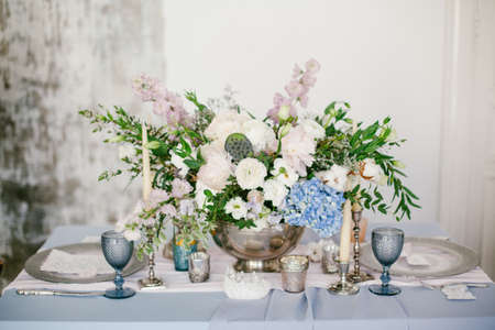 Silver candlestick and other elements of festive table wedding centerpieces decorations.の写真素材