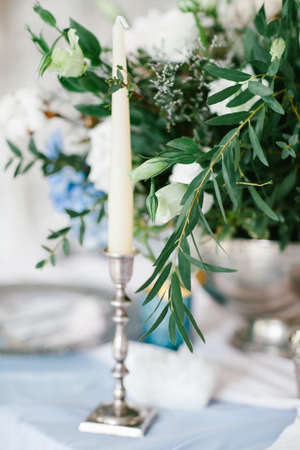 Silver candlestick as element of festive table wedding centerpieces decorations.の写真素材