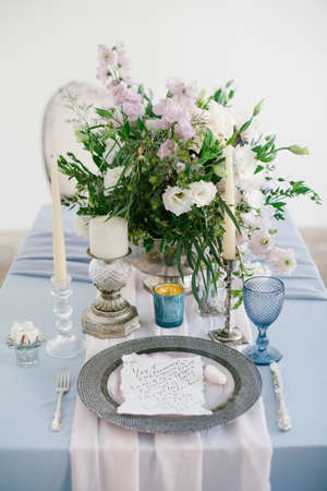 Silver candlestick and other elements of festive table wedding centerpieces decorations.の写真素材