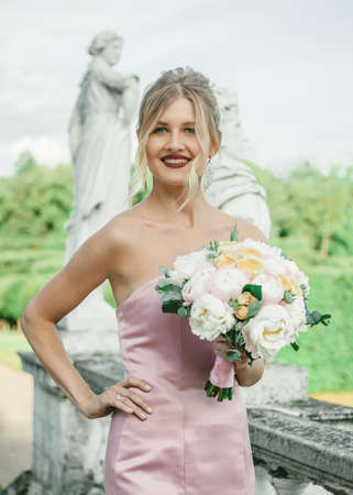 Bridal Fashion. Portrait of young beautiful modern bride with stylish make-up and and hairdo in mermaid style wedding pink dress.の写真素材
