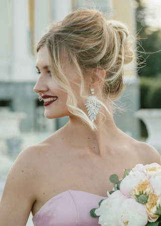 Bridal Fashion. Portrait of young beautiful modern bride with stylish make-up and and hairdo in mermaid style wedding pink dress.の写真素材