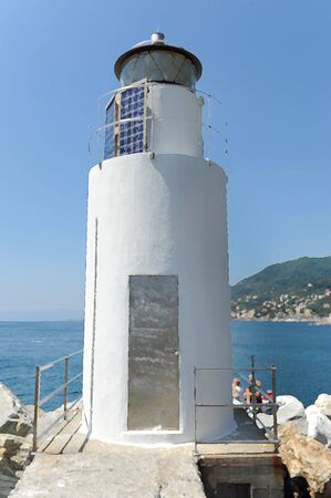 Picture with lighthouse on the rocksの写真素材