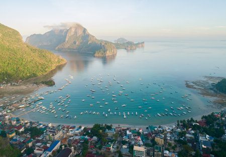 Aerial view of tropical lagoon on the background on sunny day. Tropical landscape hill, mountains rocks with rainforest and azure water of lagoon.の写真素材