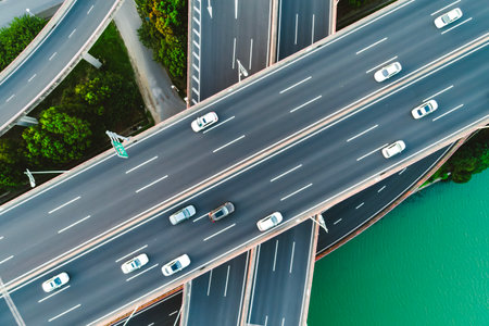 Aerial of vehicles navigate a complex highway system, showcasing overpasses and intersections.の写真素材