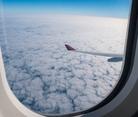 Airplane wing view above cloudy skyの写真素材