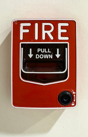Fire alarm system located indoors with a pull down feature for emergencies in a public building settingの写真素材