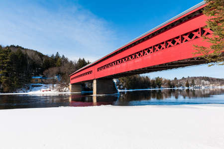 The red covered bridge on above the frozen river