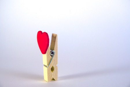 Valentines day concept. Red heart shape clothespin isolated on white backgroundの写真素材