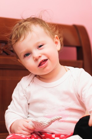 Happy toddler girl smiling, sticking her tongue outの写真素材