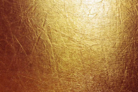 Shiny yellow leaf gold foil texture backgroundの写真素材