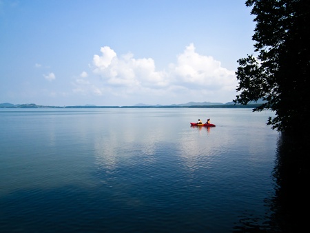 Peaceful Sea with a red boatの写真素材