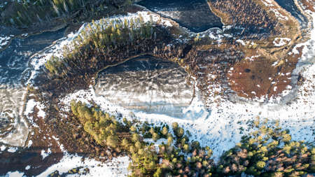 Drone view on wild nature rural forest with lake and snow melting in spring