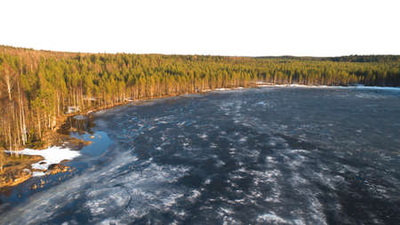 Drone view on river with melting ice, sunny spring weather.の写真素材