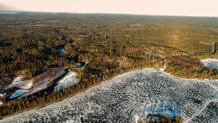 Drone view on river with melting ice, sunny spring weather.の写真素材