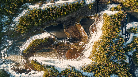 Drone view on wild nature rural forest with lake and snow melting in springの写真素材