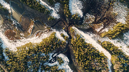 Drone view on wild nature rural forest with lake and snow melting in springの写真素材
